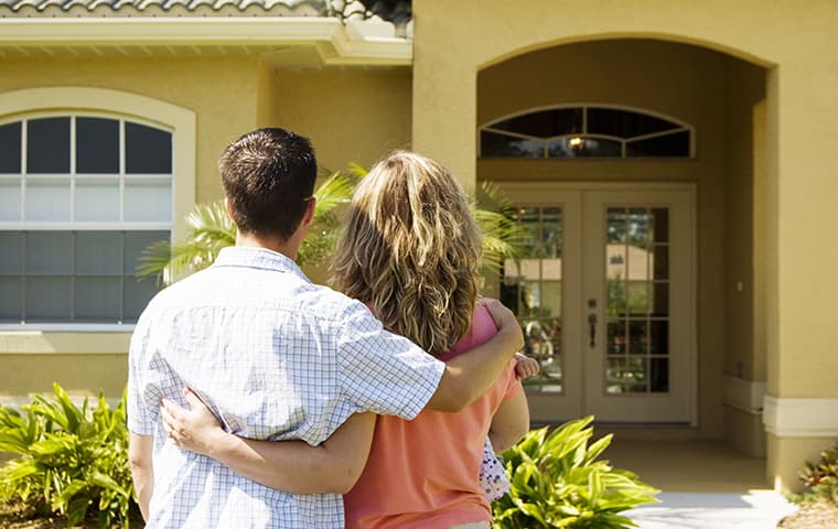 couple in front of a house